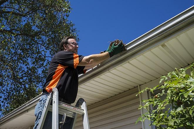 home maintenance worker repairing a leaky gutter in Affton, MO